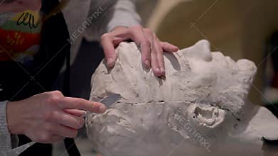 The process of creating sculpture. The sculptor is working.