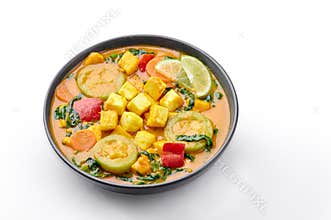 A Yellow Veg Thai Curry with Tofu and vegetables isolated on white background. Thai Food. Indian vegetable curry