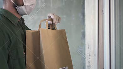 Courier is delivering the ordered products home to the customer during pandemic
