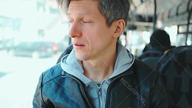 Middle aged european man Coughing sitting in city bus