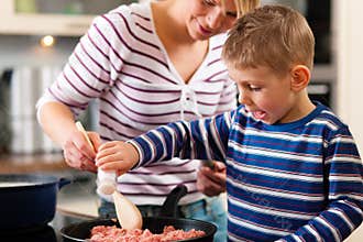 Family cooking in kitchen