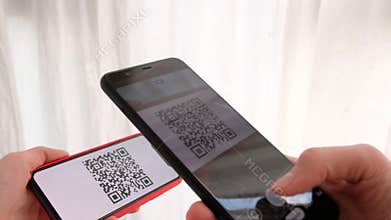 Hand holding mobile smart phone with QR code