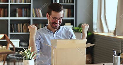 Excited man customer opening cardboard parcel box receiving gift