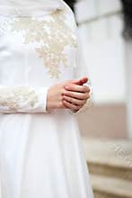 Hands of the bride. White dress for nikah, muslim wedding. Shy girl.