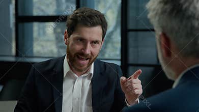 Angry aggressive displeased stressful Caucasian man businessman leader scolding corporate employee arguing with