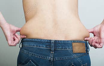 Woman pinching fat from her waist