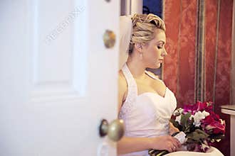 Bride waiting behind door
