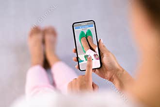 Woman Trying Virtual High Heel Shoes In Shop