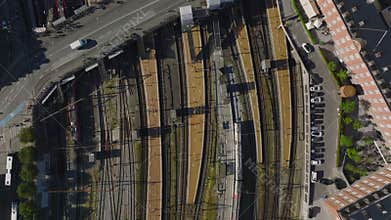 Top down panning footage of multiple railway tracks on central train station. Road bridge over tracks. Copenhagen