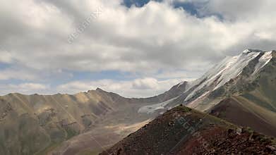 Beautiful panorama of the nature of Kyrgyzstan. Amazing view of mountain ranges, snow-capped peaks, lakes, rivers and Pamir hills.