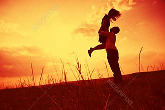 Couple embracing at sunset