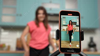 Young girl dancing and making videos for their blogs or social networks. Blogger filming vlog with trend content in