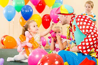 Happy children with clown on birthday party