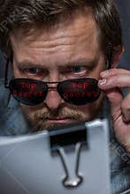 Man with top clearance reading secret documents
