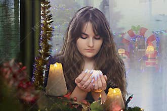 Christmas divination. Girl with candles.