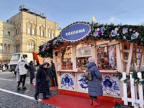 Moscow, Russia, December, 04, 2022. People walking near Khokhloma pavilion at the Christmas Fair on Red Square in Moscow