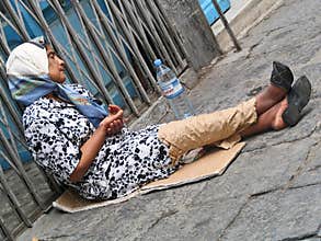 Poor woman begging for money on the street