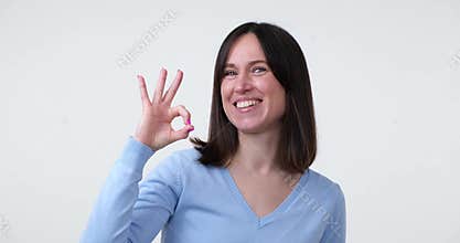 Happy woman showing OK gesture in approval