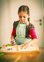 Schoolgirl baking cookies