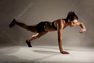 Healthy Fitness Woman doing a One Handed Pushup