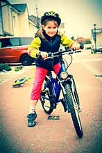 Cute schoolgirl on the bike