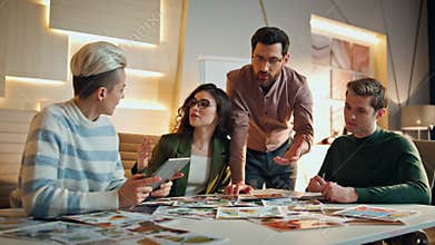 Young team creating design project in conference room. Creative workers talking.