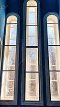 Castle window in a medieval style. Arched window on a facade of medieval wall. Ancient window, old architecture element