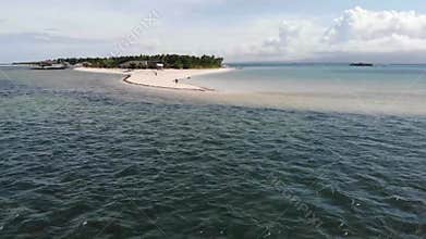 Drone flight away from a beautiful white sand beach island