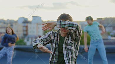 Exciting Rooftop Dance Show Featuring a Young Man&#x27;s Impressive Hip Hop Moves and His Friends Dancing in the