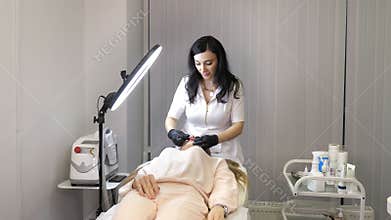 Beauty injections. Lip augmentation procedure. Lip injection plastic surgery. The cosmetologist in medical gloves