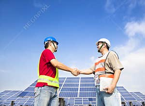 Engineers handshaking before solar power station
