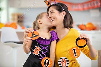 child kissing mother at halloween
