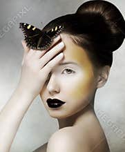 Romantic Woman holding Butterfly in her Hand. Fantasy