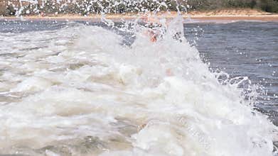 Two boys dive into a foaming wave. Live a healthy life. Be H3althy