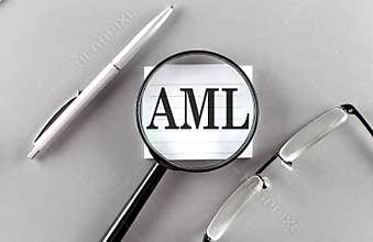 Word AML on sticky through magnifier on grey background