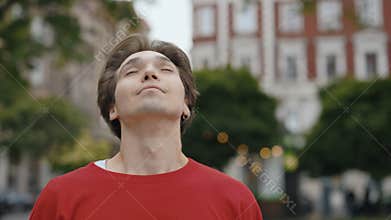 Caucasian male removes mask, breathes fresh air. Male student ytake off medical mask and smiling looking at the camera