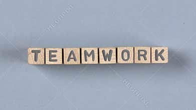 Wooden blocks with teamwork sign.