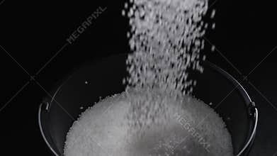 Filling the tank with plastic granules. The process of producing parts from polyethylene compound. White granules are