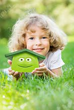 Happy child holding 3d house