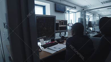 Navigation control room in the airport - a woman working with a monitor with fly paths placed on the map