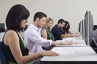 Students Reading Books In Computer Lab