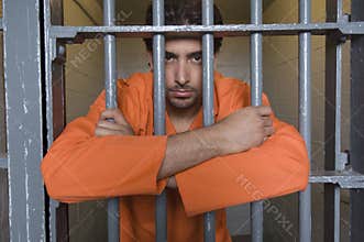 Prisoner Standing Behind Bars