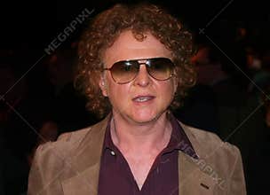 Mick Hucknall wearing a brown jacket and sunglasses at a Labour conference in Manchester, UK.