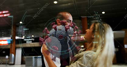 Animation of floating macro Covid-19 cell over Caucasian couple embracing at airport
