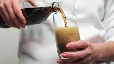 Girl pouring glass with beverage