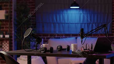Nobody in cozy ambient room with podcast equipment, microphone and headphones