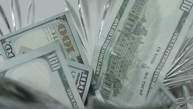 100 Dollar Bills Fall, Drop Into Crystal Bowl Close Up