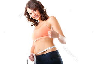 Diet - young woman is measuring her waist