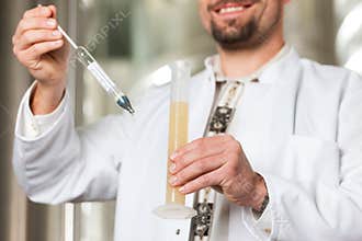 Beer brewer in his brewery examining