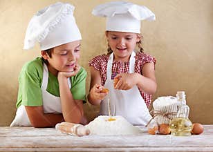 Kids preparing a cake